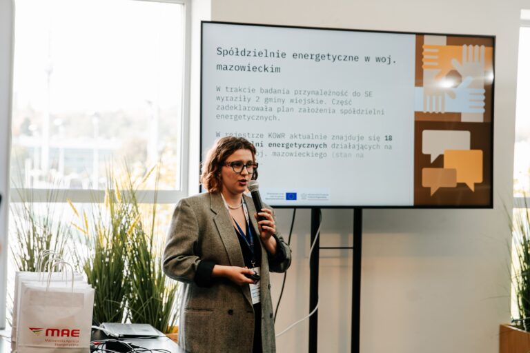 Przedstawicielka Mazowieckiej Agencji Energetycznej prowadzi prezentację podczas 15. Forum Rozwoju Mazowsza. Na ekranie za nią widoczny jest slajd o spółdzielniach energetycznych w województwie mazowieckim.